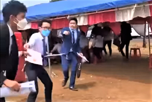 Nhân viên môi giới chạy tán loạn để diễn cảnh tranh nhau chốt cọc, tạo cơn sốt đất ảo. Ảnh cắt từ clip